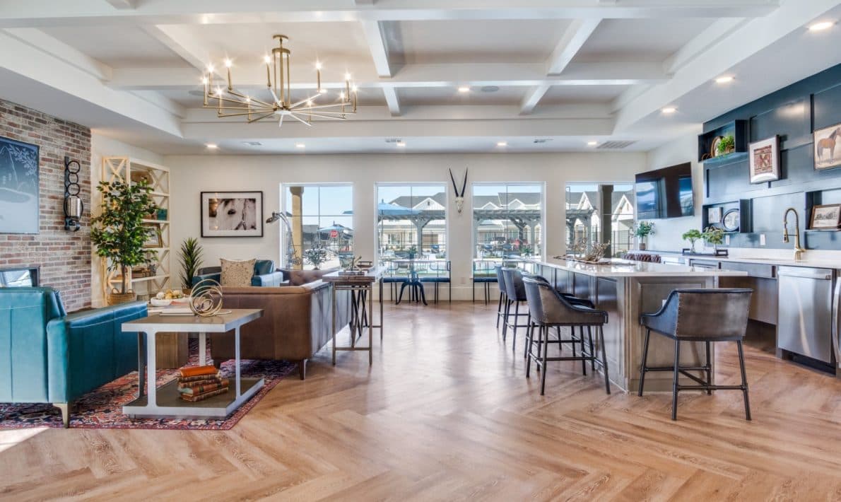 The clubhouse at LEO at Bethel Place, lounge seating and a kitchen island